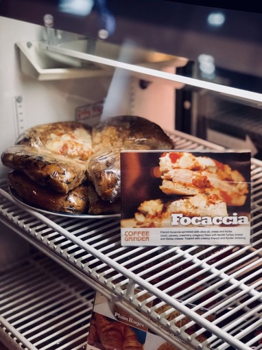 Focaccia sandwiches wrapped in the cooler next to their menu card