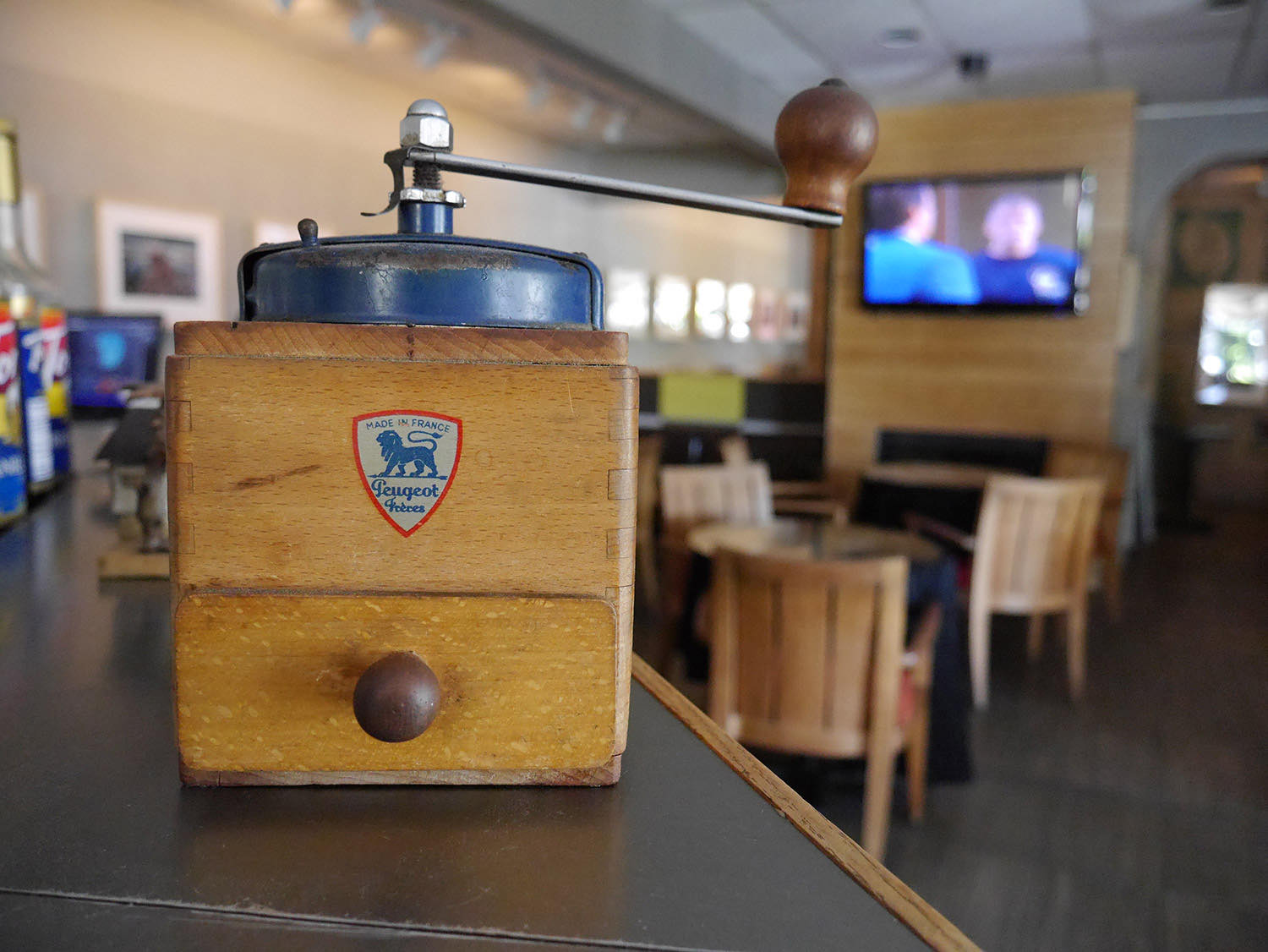 An antique Peugeot hand coffee grinder on the counter of The Coffee Grinder