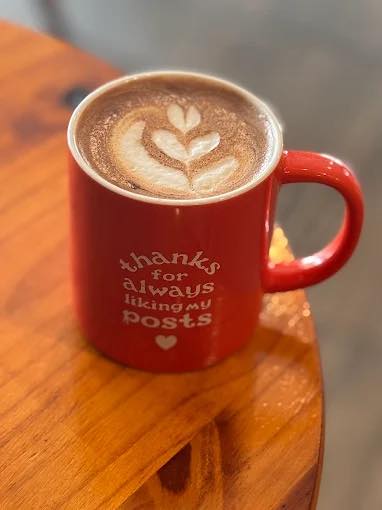 Hot chocolate with latte art in a red mug