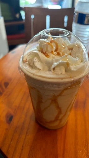 A frozen Kona Mocha topped with whipped cream and a caramel drizzle