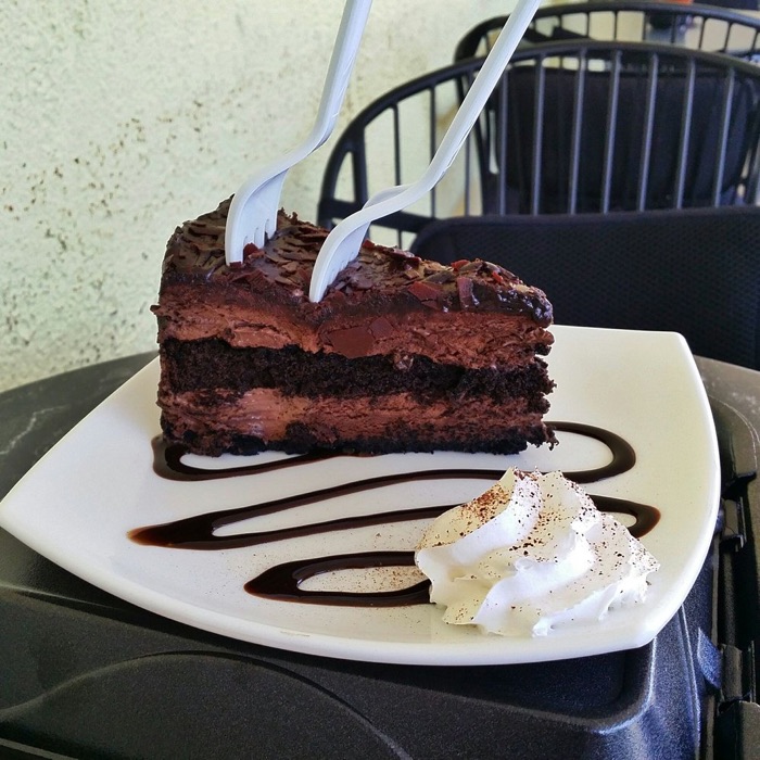 A slice of Belgian chocolate mousse cake with whipped cream