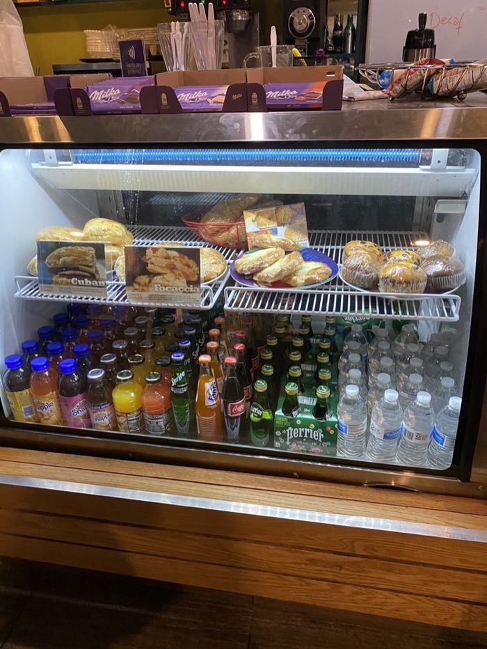 Bottled juices, sodas and water in the cooler under the pastry shelf