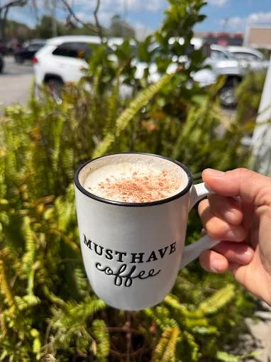 A coffee mug held up on the patio