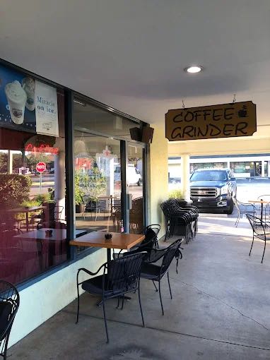 The patio tables under the hanging Coffee Grinder sign
